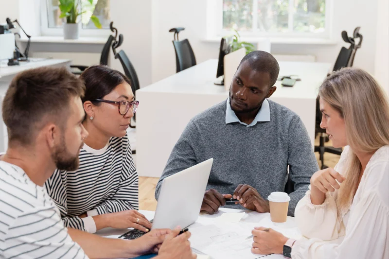 Team of professionals collaborating on a customized solution architecture and implementation roadmap for Microsoft Fabric.