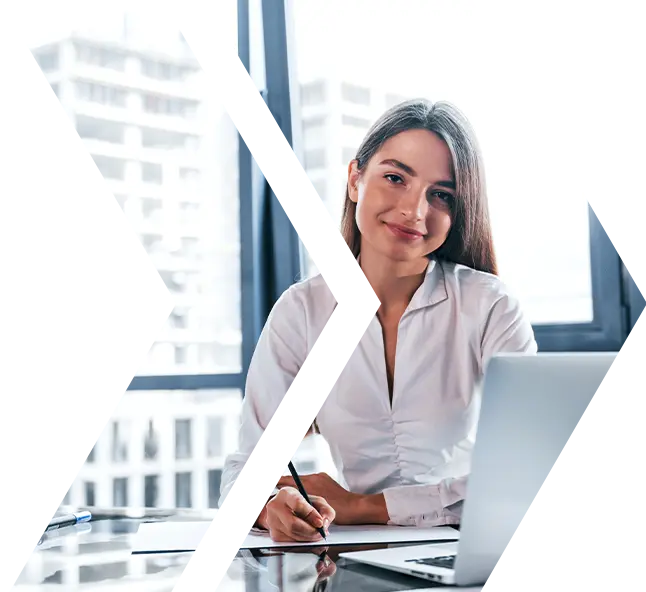 Professional woman working on content creation at a desk, promoting Exigo Tech's AI Content Creator for streamlined, accurate, and tailored content generation.