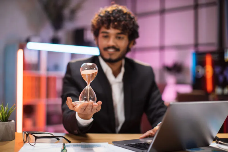 Exigo Tech Perks: A professional working with a laptop, symbolizing a flexible timing policy for work-life balance.